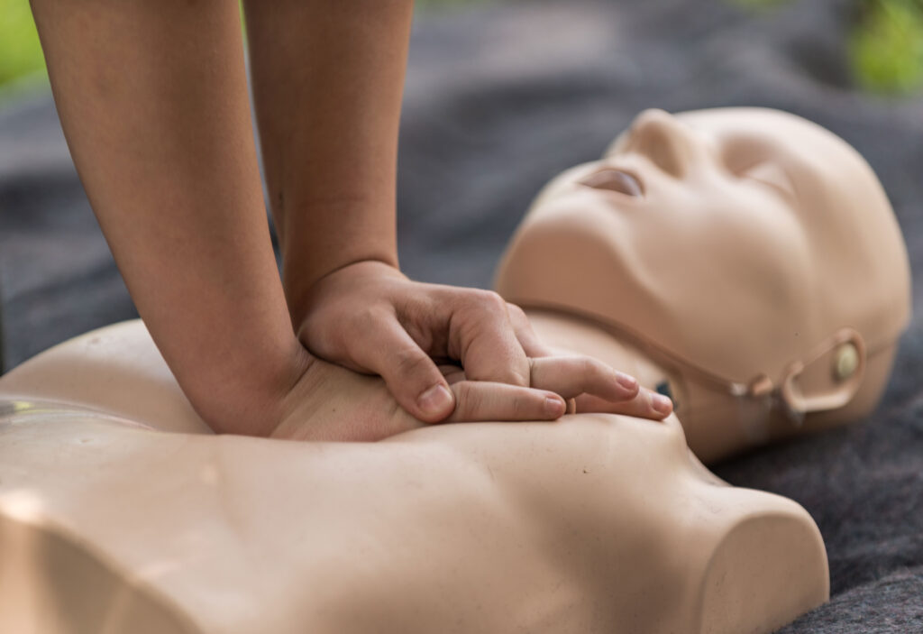 Closeup of someone performing CPR on a training dummy