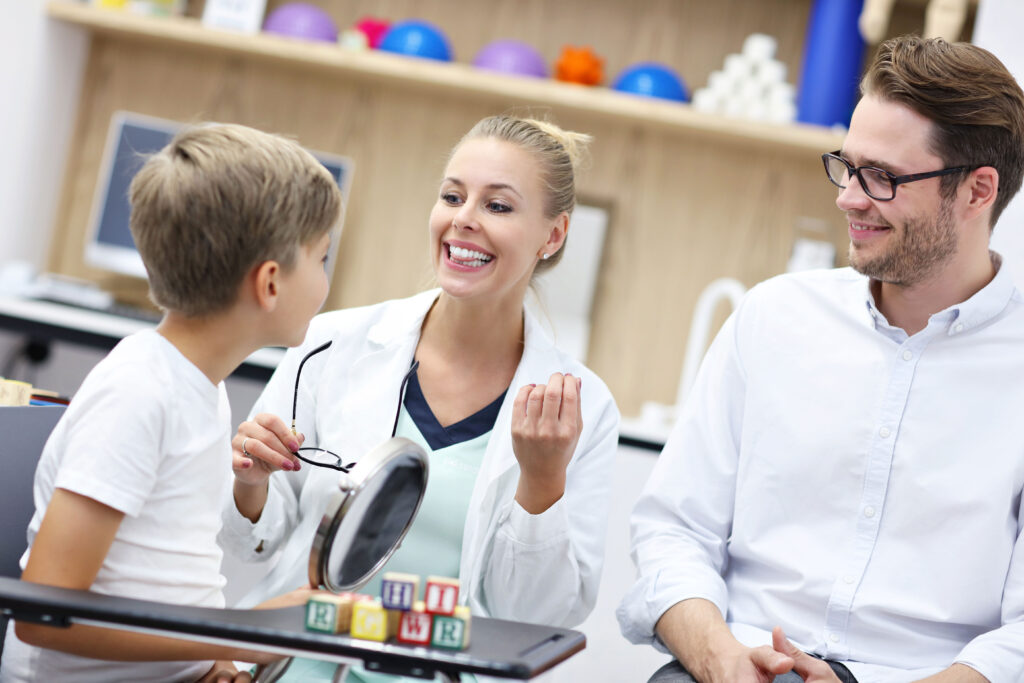 Speech therapist working with an elementary age student in a school setting