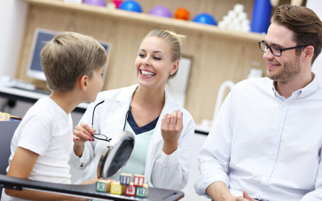 Speech therapist working with an elementary age student in a school setting