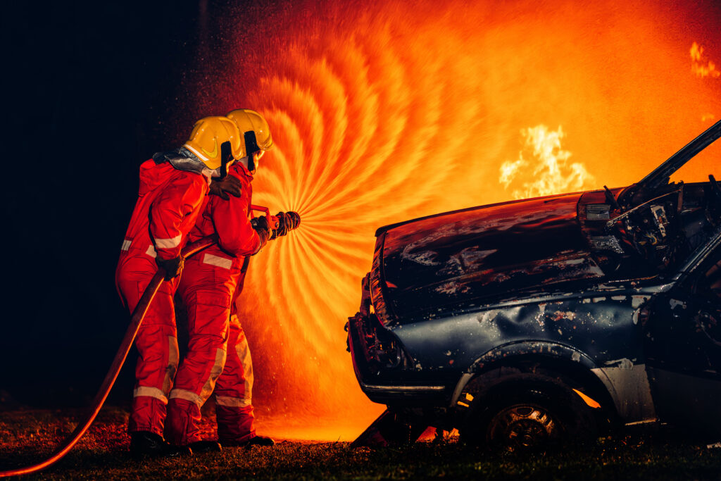 Fire fighters spraying water on a large blaze