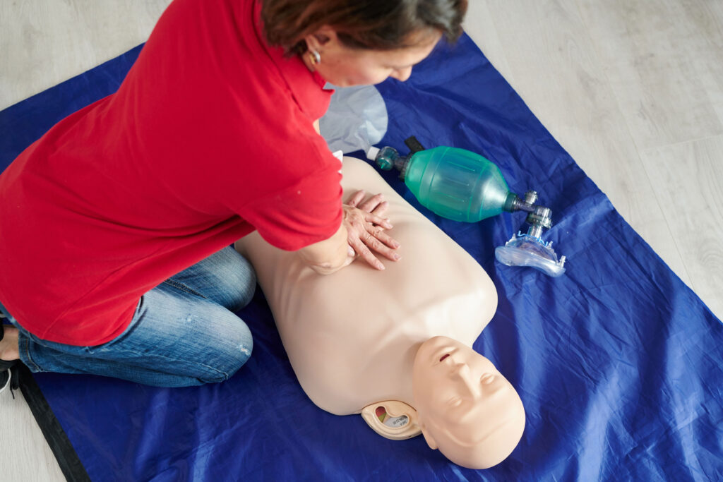Woman performing CPR on training dummy