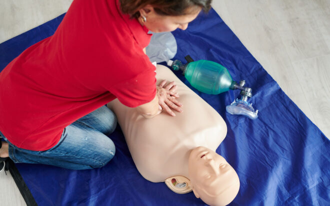 Woman performing CPR on training dummy