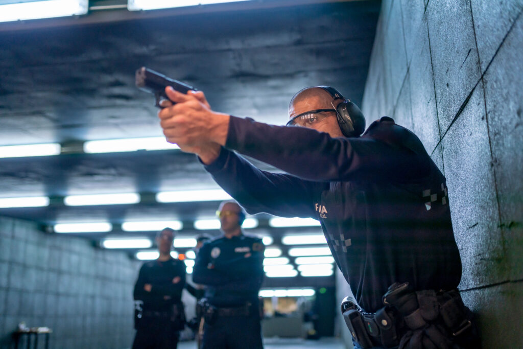Police officer with pistol in training gallery