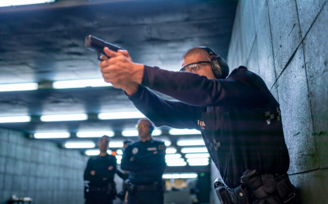 Police officer with pistol in training gallery