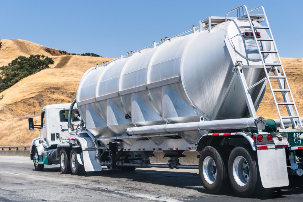 Tanker truck driving down a highway