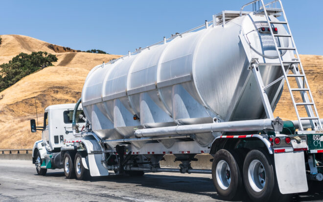 Tanker truck driving down a highway