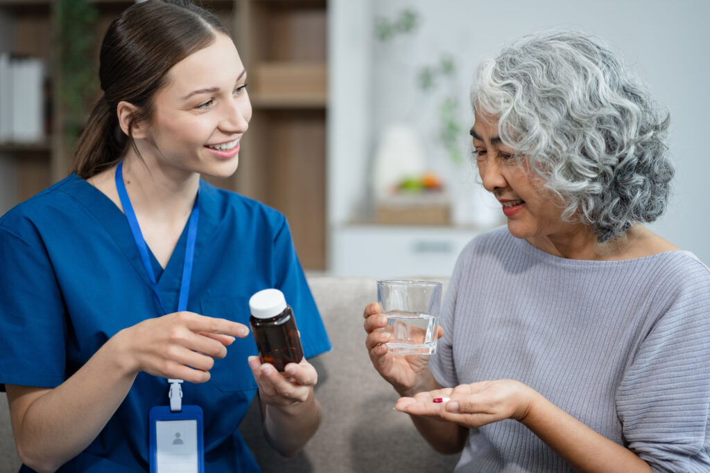 Nurse discussing medication with elderly patient in a home care setting